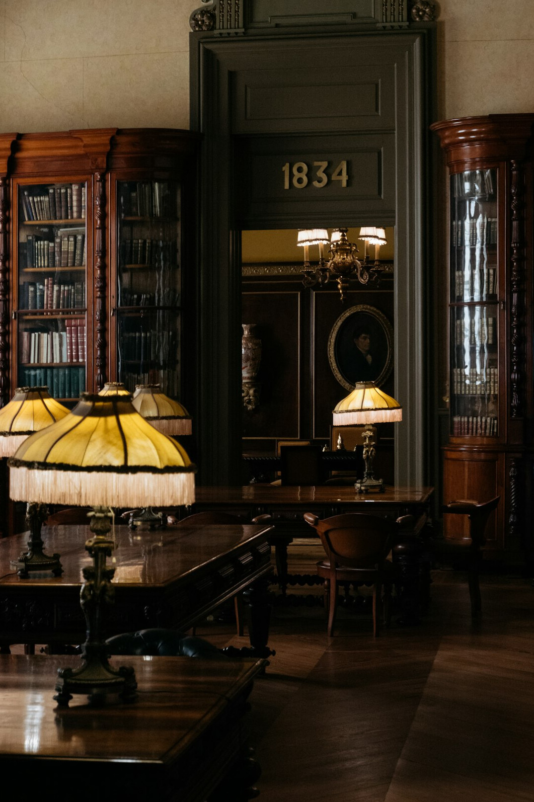 Atmospheric old library with warm lamps and tall bookshelves