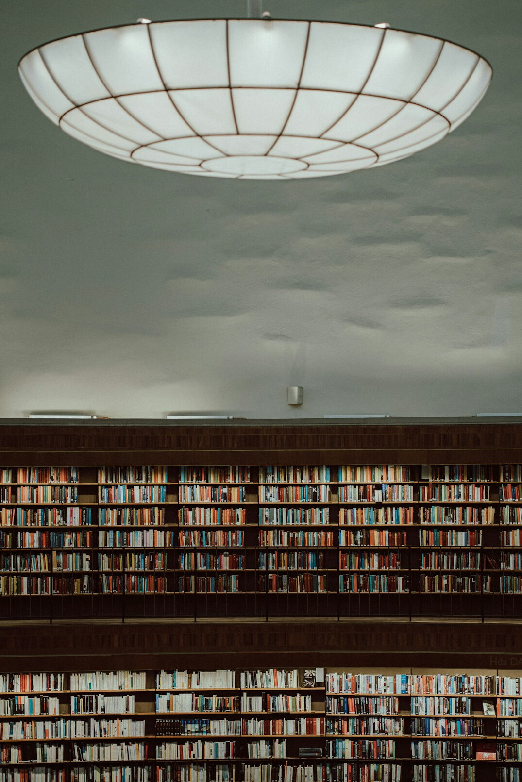 Library with high bookshelves and warm light